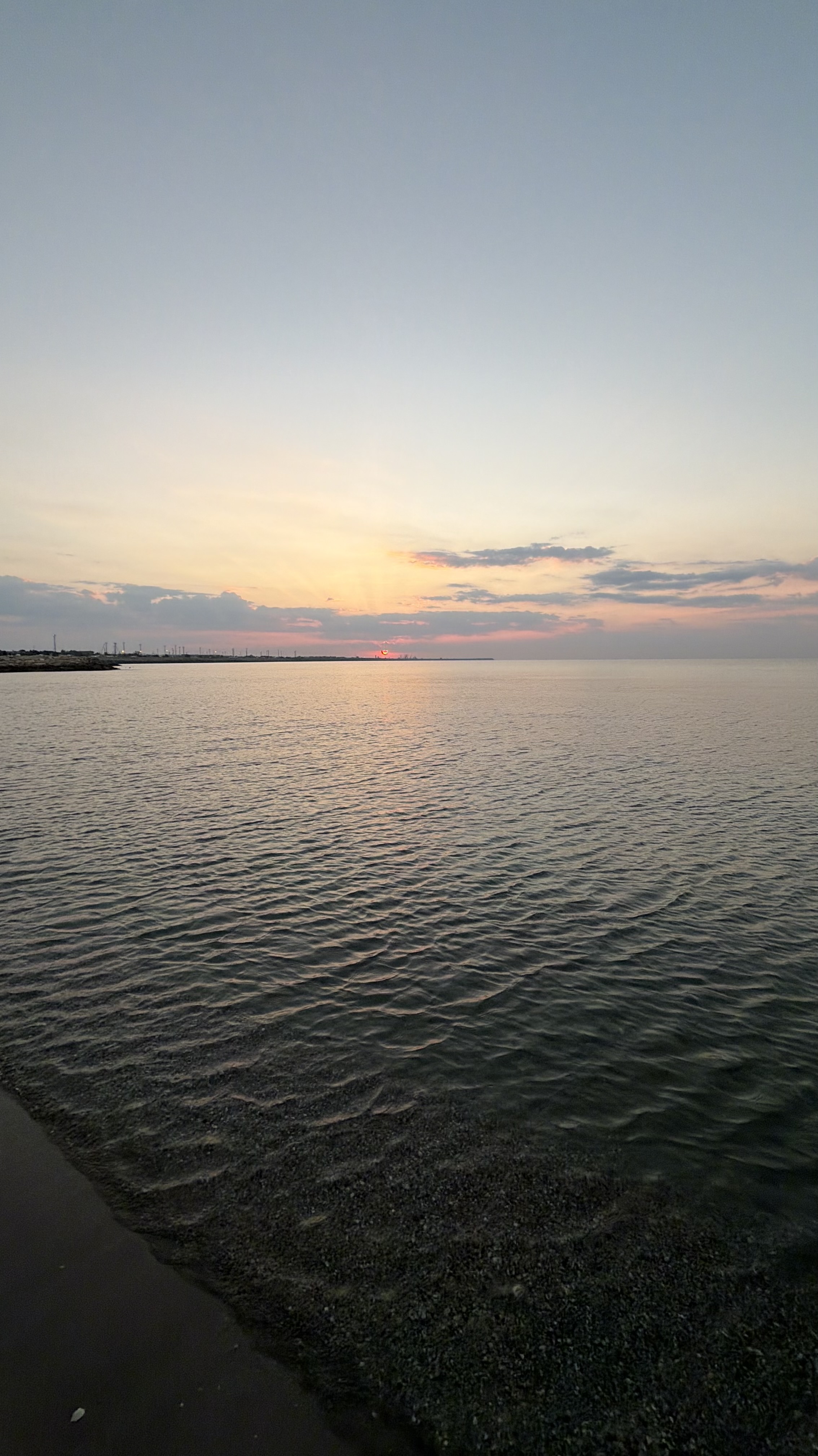 Sunset over still water, taken in portrait