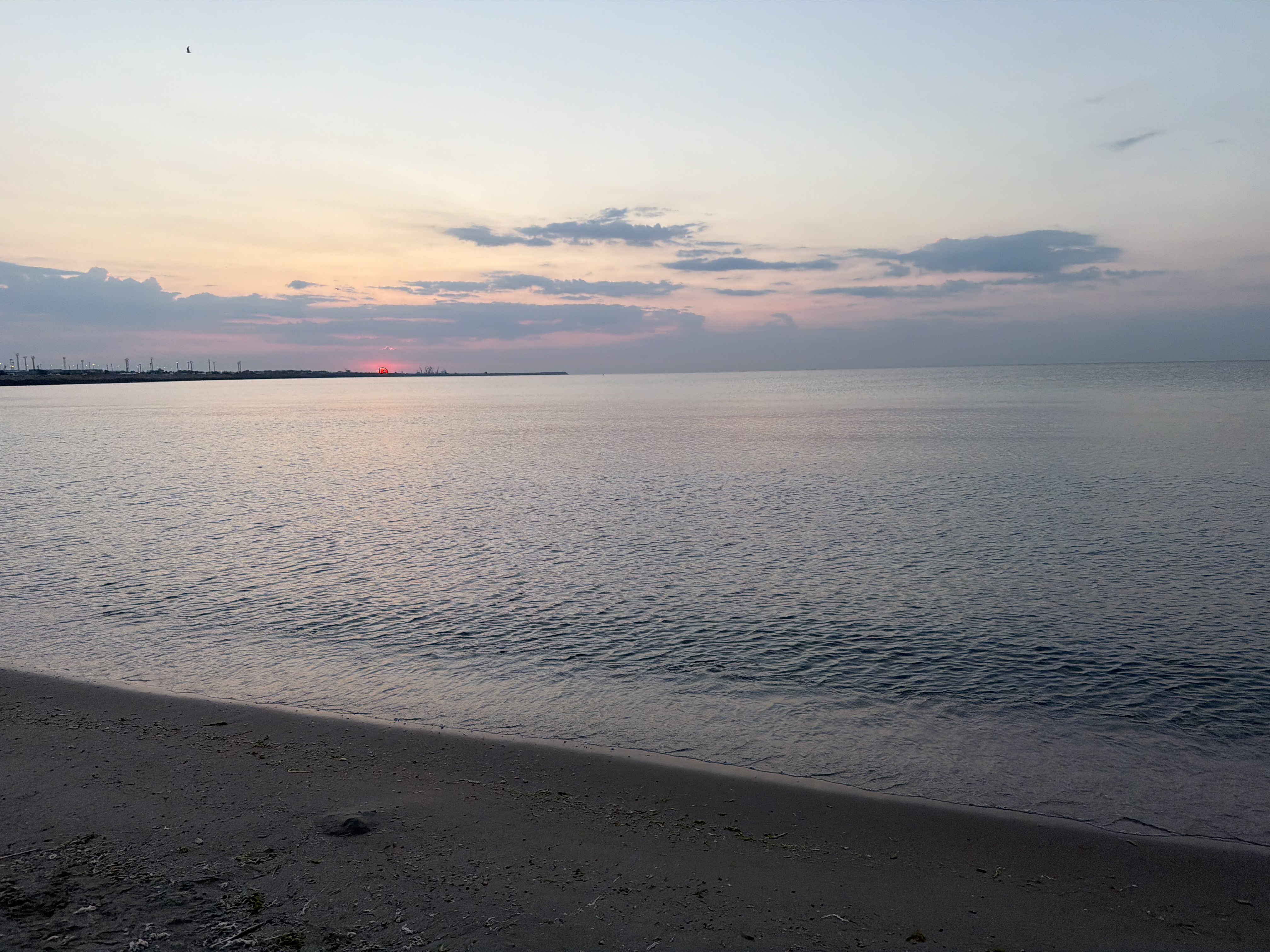Quiet beach and flat sea at sunset